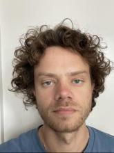 Photo of Aiden Farrell wearing a blue shirt on a white background