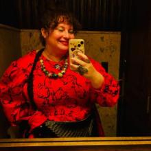 A person in a red dress with bunnies drawn on it 