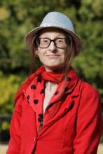 Woman in red blouse, red scarp, and a silver sparkly hat